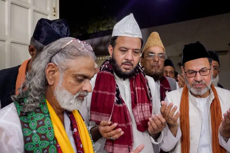 Community elders and scholars in collective prayer