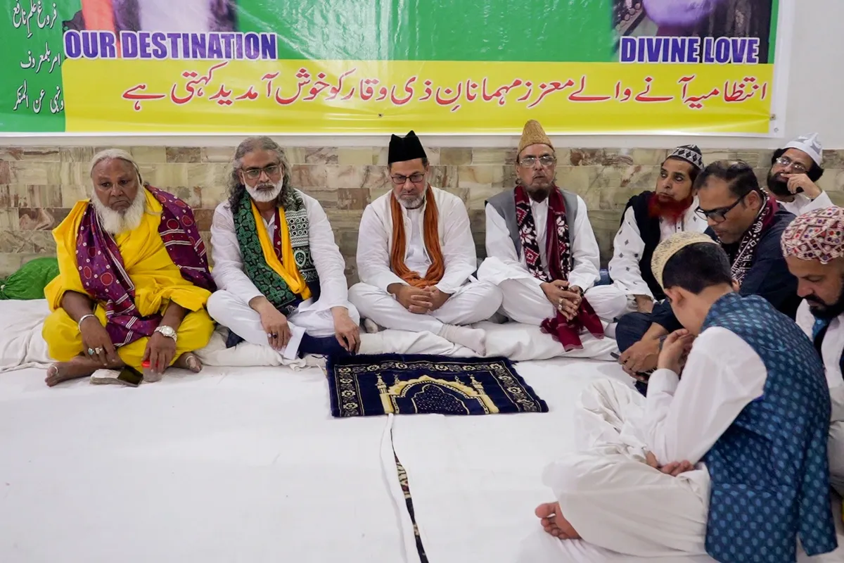 Dignitaries and scholars seated with welcome banner